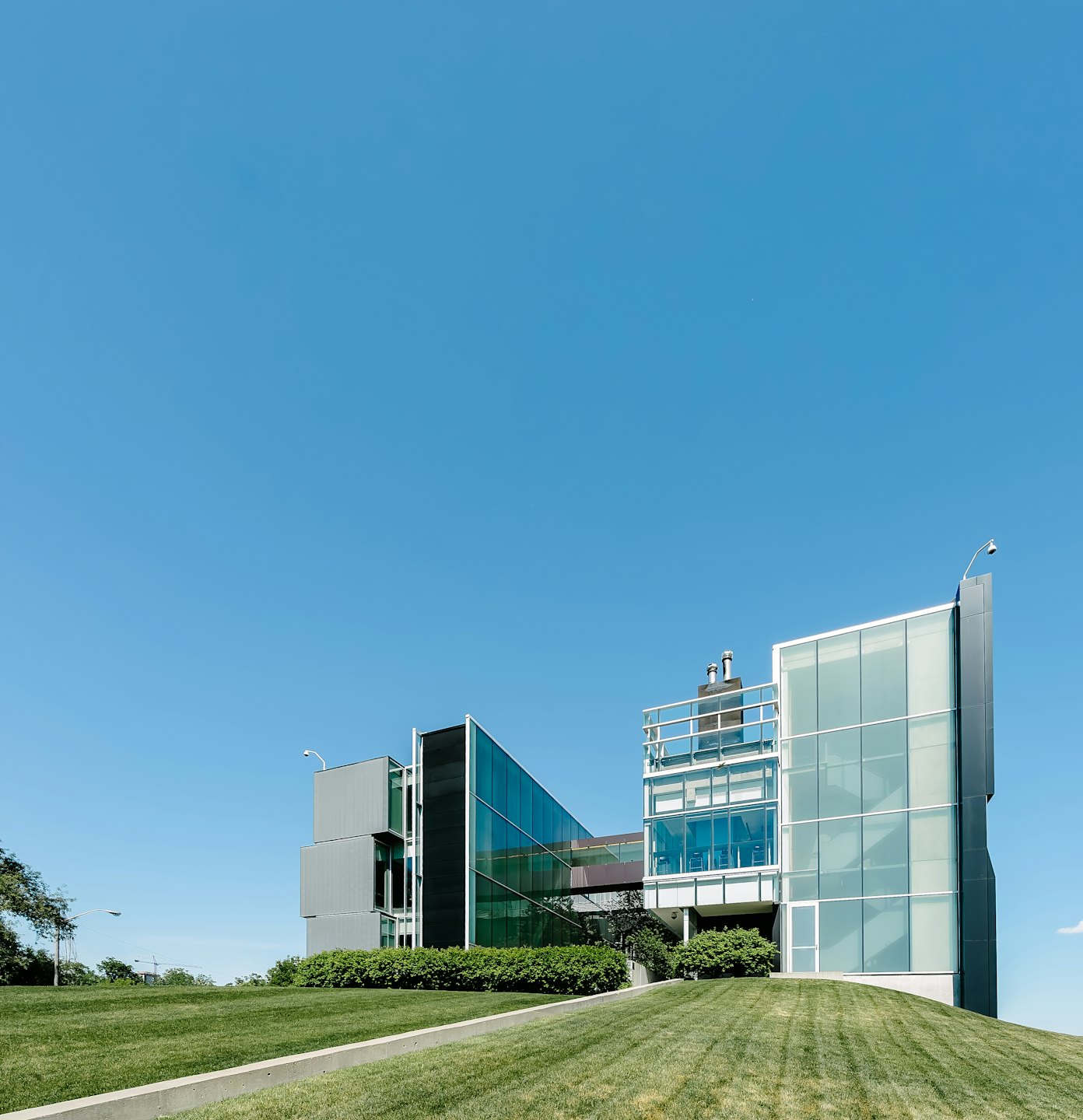 Moderno edificio per uffici in vetro e grigio dal design geometrico.
